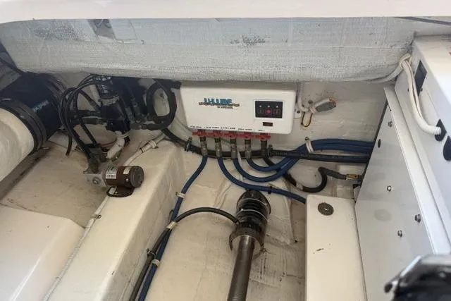 Slide: The Image of Engine compartment of a 2010 Tiara Yachts 3900 Open, showcasing wiring and mechanical components. - 40