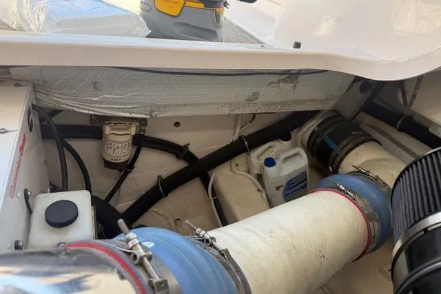 Slide: The Image of Engine compartment of a 2010 Tiara Yachts 3900 Open, showcasing hoses and maintenance equipment. - 41