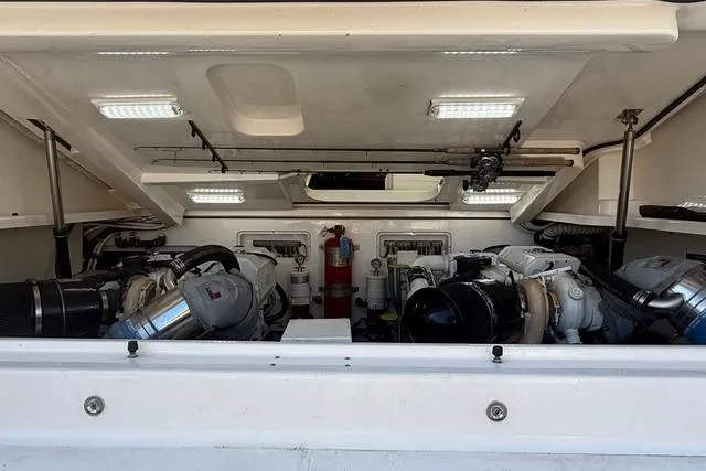 Slide: The Image of Engine room of 2010 Tiara Yachts 3900 Open, featuring dual engines and fishing rods. - 45