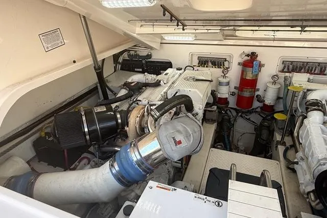 Slide: The Image of Engine room of 2010 Tiara Yachts 3900 Open, showcasing mechanical components and fire safety equipment. - 47
