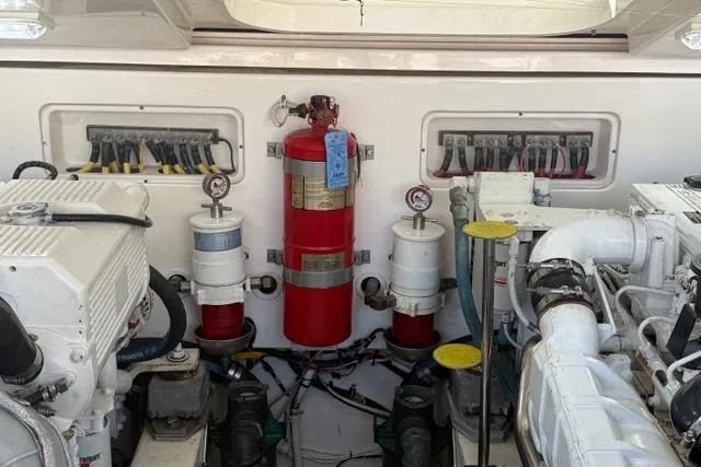 Slide: The Image of Engine room of 2010 Tiara Yachts 3900 Open with fire extinguisher and machinery. - 48