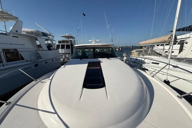 Slide: The Image of 2010 Tiara Yachts 3900 Open docked among other boats in a marina. - 6
