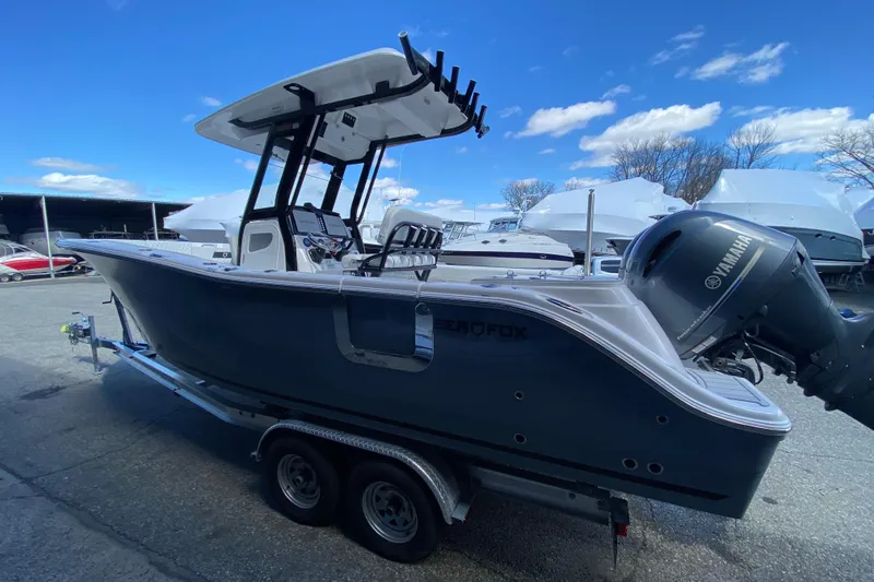 Slide: The Image of 2026 Sea Fox 268 Commander boat with Yamaha engine on trailer under blue sky. - 1