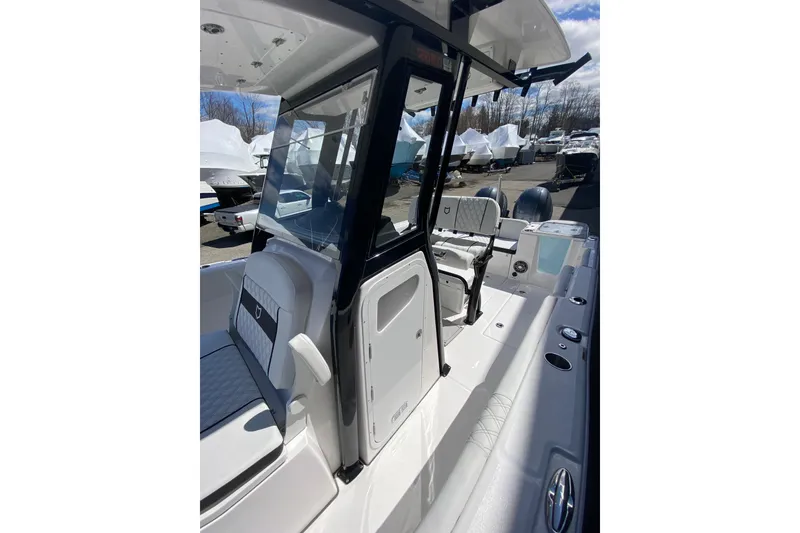 Slide: The Image of 2026 Sea Fox 268 Commander boat interior with seating and console, docked outdoors. - 12