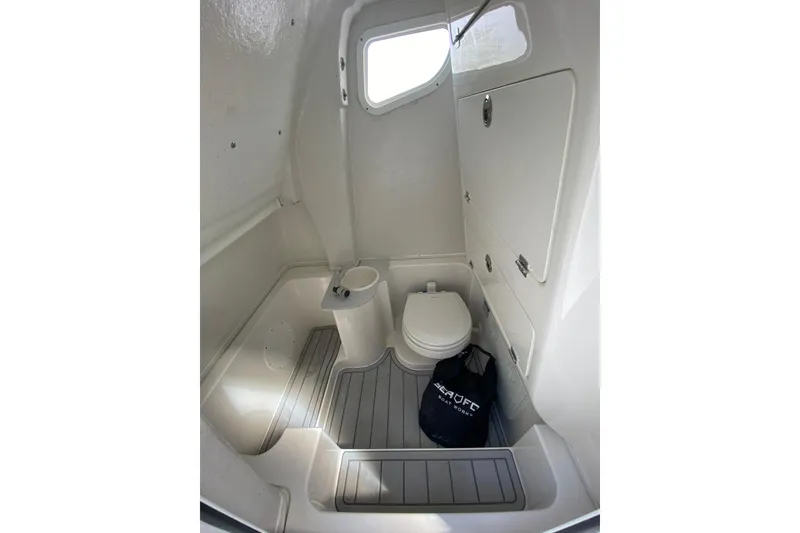 Slide: The Image of Interior of 2026 Sea Fox 268 Commander boat bathroom with toilet and storage. - 13