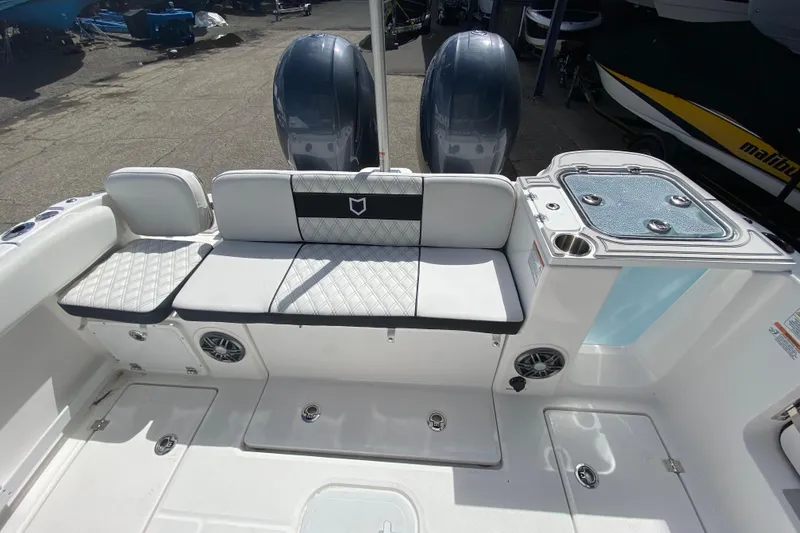 Slide: The Image of 2026 Sea Fox 268 Commander boat interior with seating and dual engines. - 2