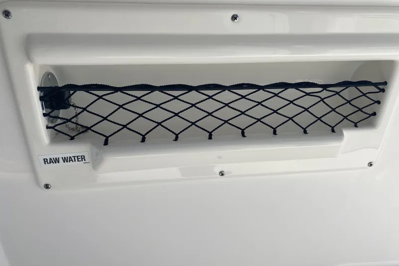 Slide: The Image of 2026 Sea Fox 268 Commander raw water compartment with netting for storage. - 22