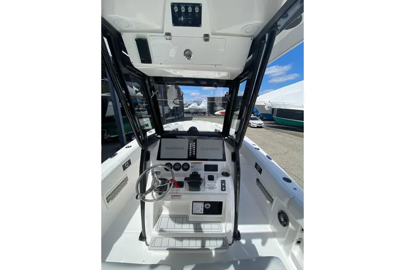 Slide: The Image of 2026 Sea Fox 268 Commander boat helm with Garmin navigation system and steering wheel. - 7