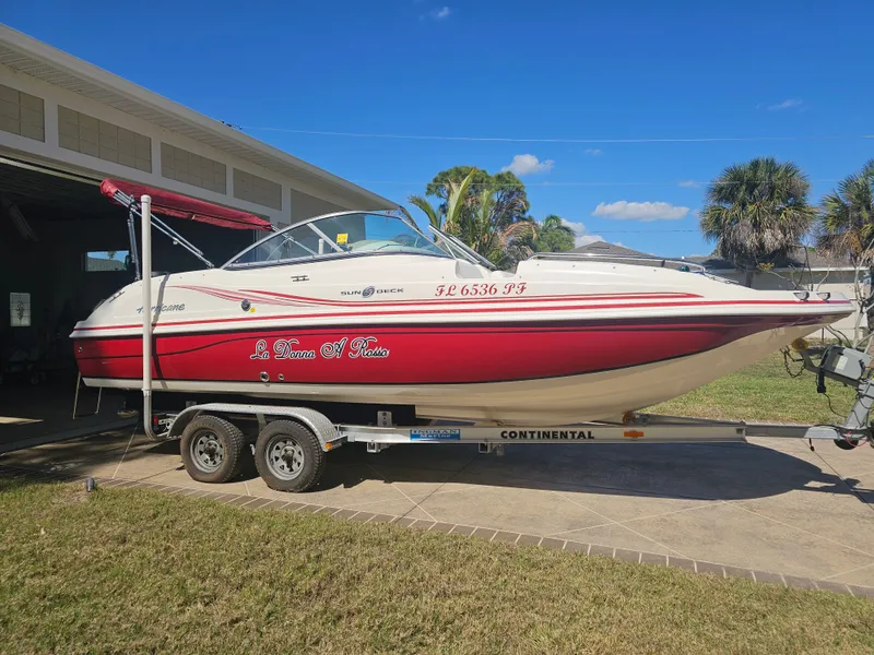 The Image of 2012 Godfrey Hurricane 217 Sundeck boat on trailer outdoors. - 0