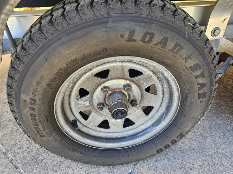 Slide: The Image of Close-up of a Loadstar tire on a 2012 Godfrey Hurricane 217 Sundeck. - 24