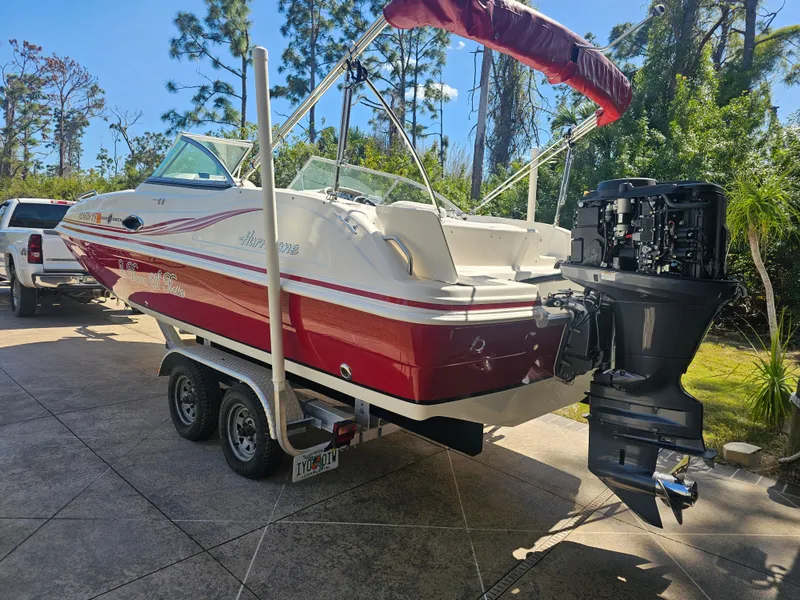 Slide: The Image of 2012 Godfrey Hurricane 217 Sundeck boat on trailer outdoors. - 5