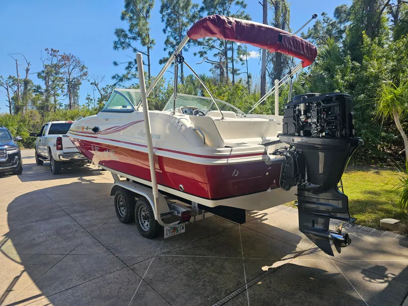 Slide: The Image of 2012 Godfrey Hurricane 217 Sundeck boat parked on trailer outdoors. - 7