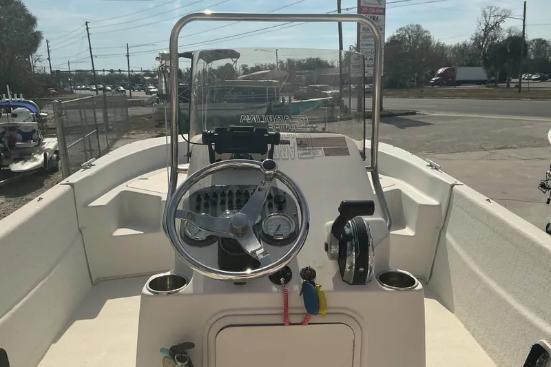 Slide: The Image of 2014 Carolina Skiff 198 DLV boat console with steering wheel and controls. - 10
