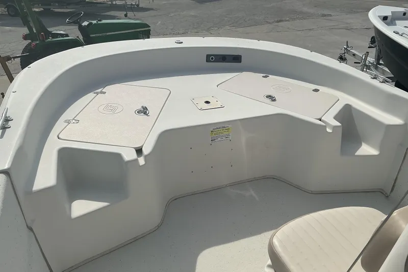 Slide: The Image of 2014 Carolina Skiff 198 DLV boat interior with storage compartments and seating. - 11