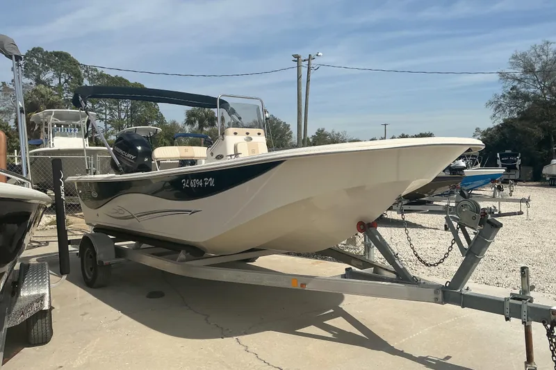 Slide: The Image of 2014 Carolina Skiff 198 DLV boat on trailer, parked outdoors. - 12