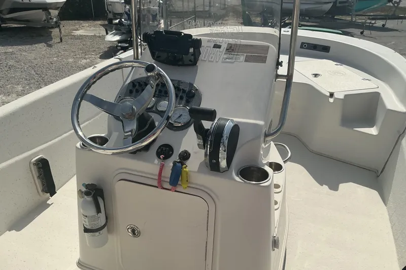 Slide: The Image of 2014 Carolina Skiff 198 DLV boat console with steering wheel and controls. - 6