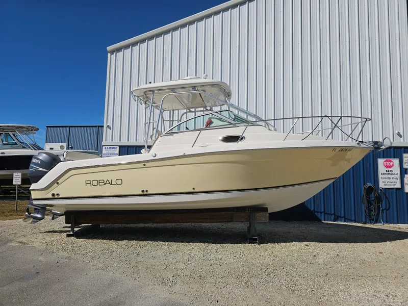 The Image of 2006 Robalo R265 Walkaround boat in front of warehouse. - 0