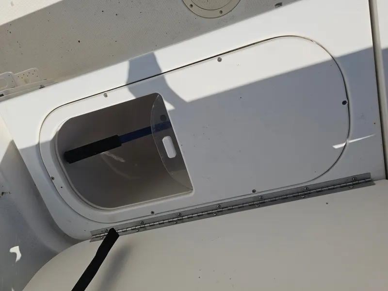 Slide: The Image of Robalo R265 Walkaround 2006 storage compartment with shovel. - 11