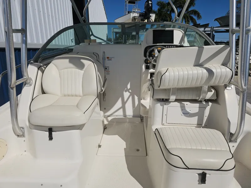 Slide: The Image of Interior of a 2006 Robalo R265 Walkaround boat with white seating. - 16