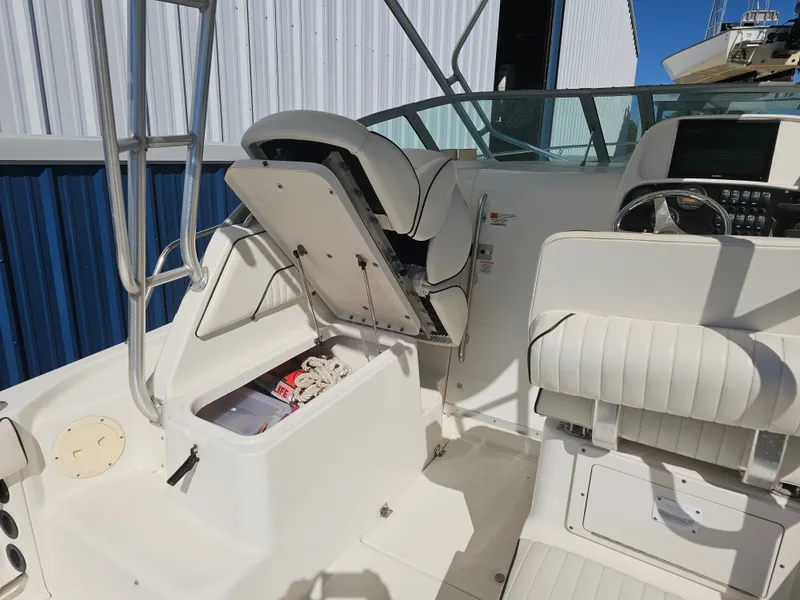 Slide: The Image of 2006 Robalo R265 Walkaround boat with storage compartment and helm console. - 17