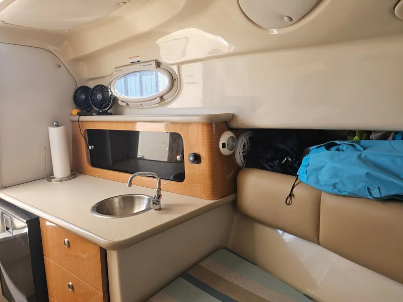 Slide: The Image of Interior of 2006 Robalo R265 Walkaround with sink and storage space. - 24