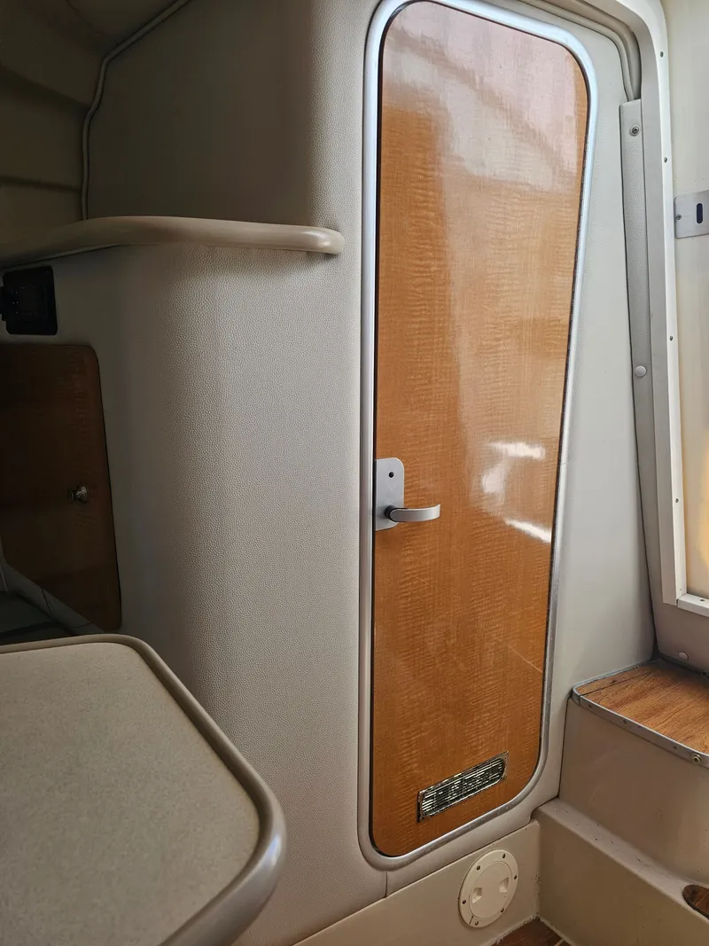 Slide: The Image of Interior of a 2006 Robalo R265 Walkaround with wooden door. - 25