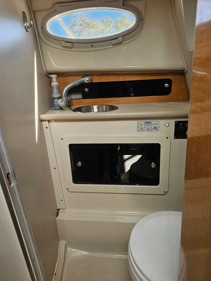 Slide: The Image of Interior of 2006 Robalo R265 Walkaround with sink and toilet. - 26