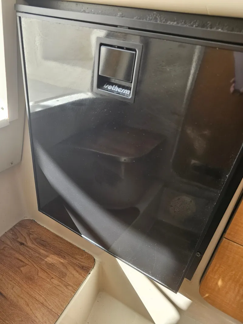 Slide: The Image of Interior of a 2006 Robalo R265 Walkaround boat with refrigerator. - 31