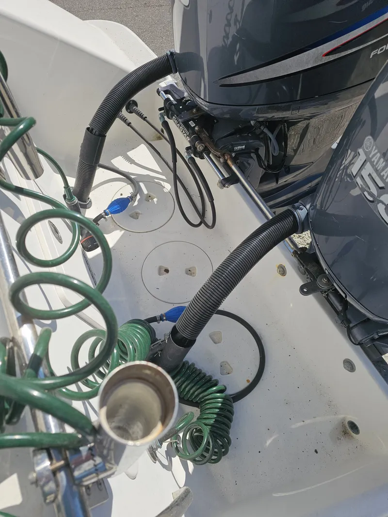 Slide: The Image of 2006 Robalo R265 Walkaround with Yamaha outboard motors and green hoses. - 39