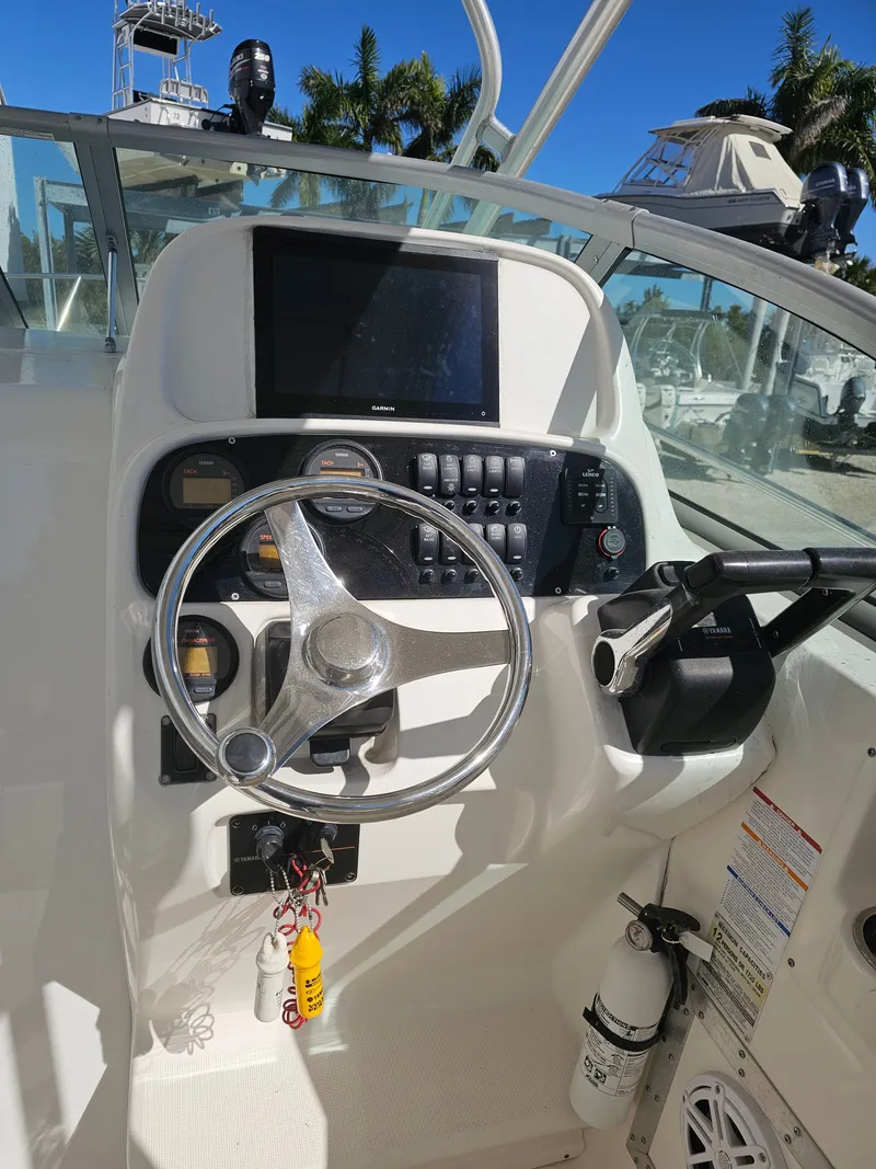 Slide: The Image of 2006 Robalo R265 Walkaround boat helm with steering wheel and instruments. - 4