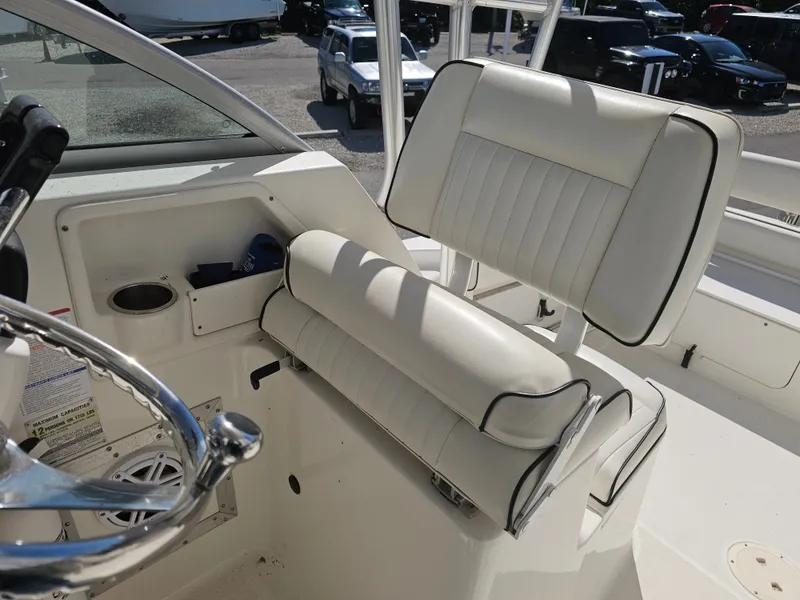 Slide: The Image of Interior of a 2006 Robalo R265 Walkaround boat with white seating. - 7