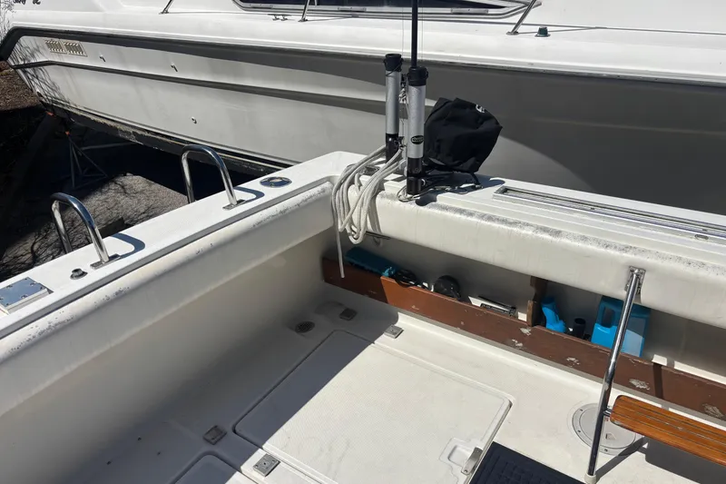 Slide: The Image of 1991 Tiara Yachts 3100 Open boat deck with fishing rod holders and storage compartments. - 12