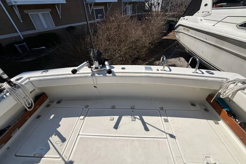 Slide: The Image of 1991 Tiara Yachts 3100 Open boat deck with fishing rod holders and storage compartments. - 14