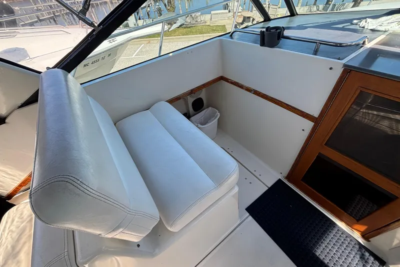 Slide: The Image of Interior of 1991 Tiara Yachts 3100 Open, featuring white seating and wooden accents. - 17