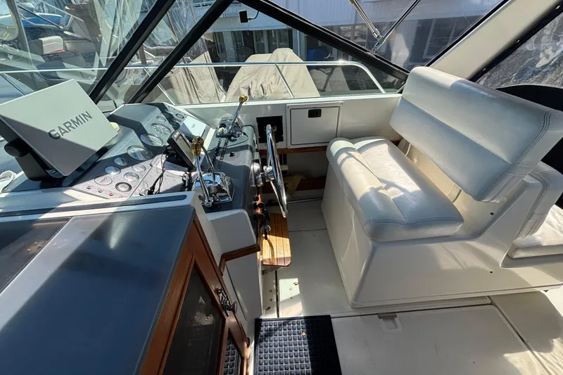 Slide: The Image of 1991 Tiara Yachts 3100 Open helm with Garmin navigation and white seating. - 20