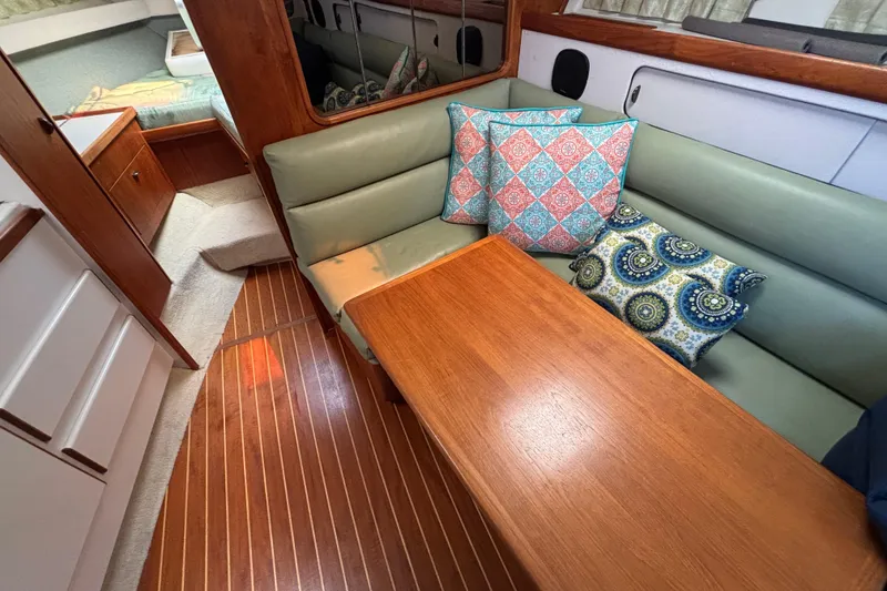 Slide: The Image of Interior of 1991 Tiara Yachts 3100 Open with wooden table and colorful cushions. - 25