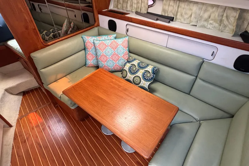 Slide: The Image of Interior of 1991 Tiara Yachts 3100 Open with cushioned seating and wooden table. - 26