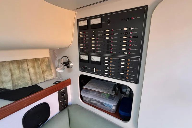 Slide: The Image of Control panel inside a 1991 Tiara Yachts 3100 Open, featuring switches and meters. - 33