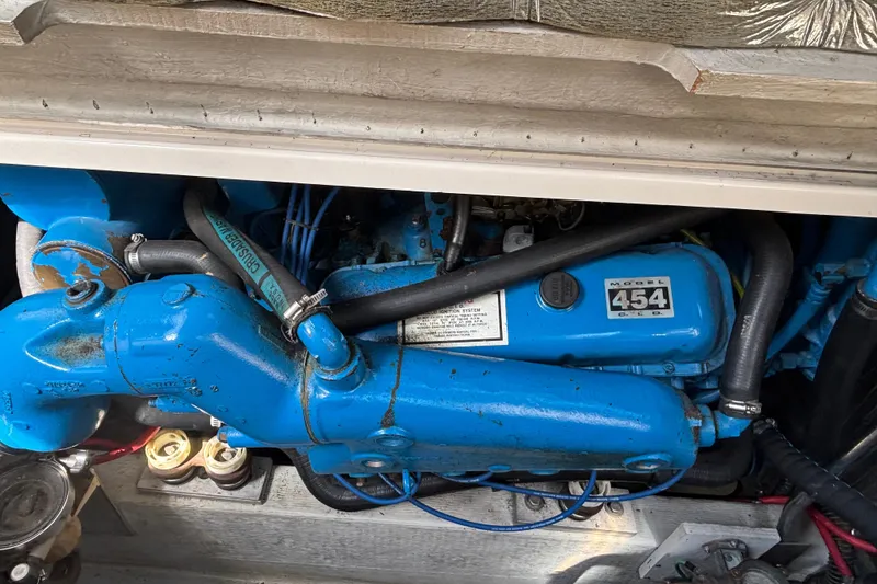 Slide: The Image of Engine compartment of a 1991 Tiara Yachts 3100 Open, featuring a blue Model 454 engine. - 35