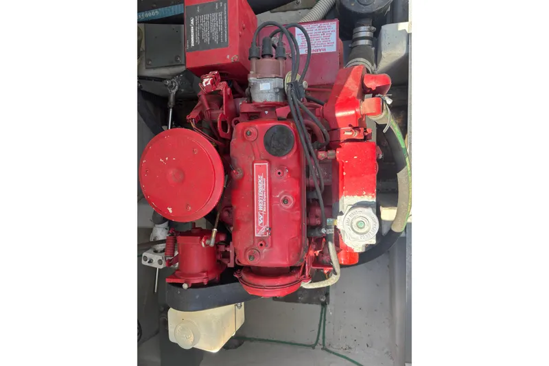 Slide: The Image of Engine of a 1991 Tiara Yachts 3100 Open, featuring red components and wiring. - 37