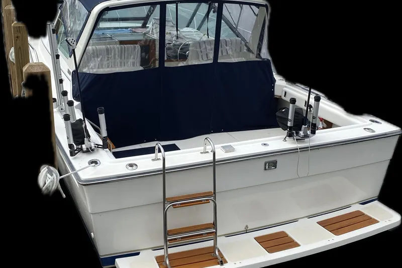 Slide: The Image of 1991 Tiara Yachts 3100 Open boat with fishing rod holders and swim ladder. - 5