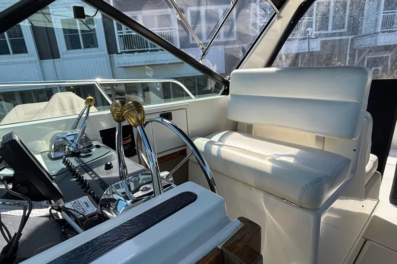 Slide: The Image of Interior of a 1991 Tiara Yachts 3100 Open, featuring helm controls and seating. - 8
