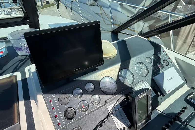Slide: The Image of 1991 Tiara Yachts 3100 Open dashboard with Garmin and Fish Hawk electronics. - 9