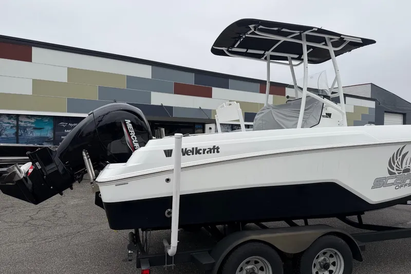 Slide: The Image of 2021 Wellcraft 202 Fisherman boat on trailer, featuring a Mercury outboard motor. - 1