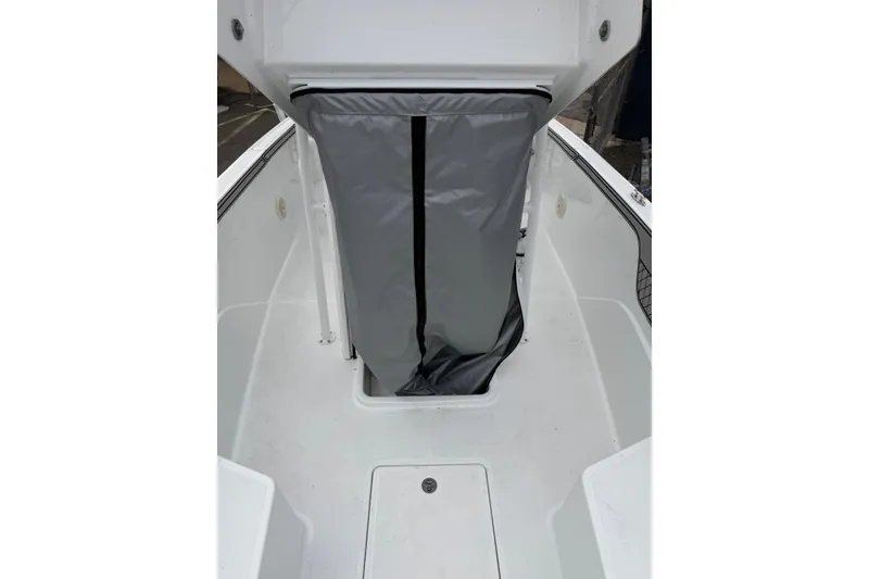 Slide: The Image of 2021 Wellcraft 202 Fisherman boat interior with storage compartment and protective cover. - 14