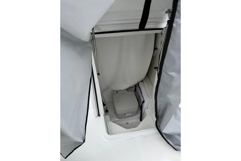 Slide: The Image of 2021 Wellcraft 202 Fisherman boat storage compartment with cover partially open. - 15