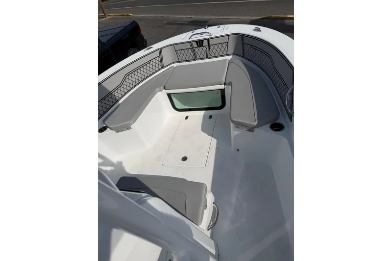 Slide: The Image of 2021 Wellcraft 202 Fisherman boat interior with gray seating and storage compartments. - 16