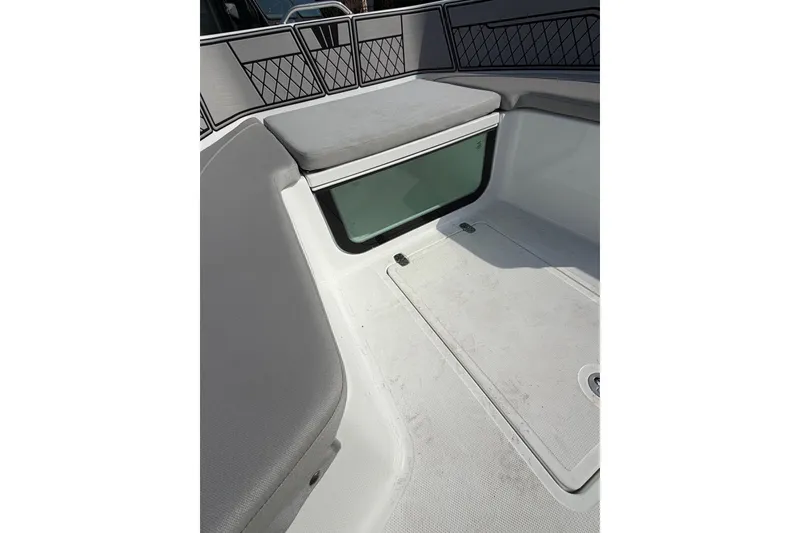 Slide: The Image of Interior view of a 2021 Wellcraft 202 Fisherman boat, featuring cushioned seating and storage. - 17