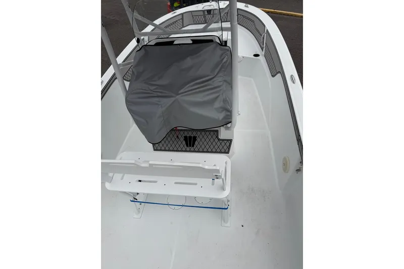 Slide: The Image of 2021 Wellcraft 202 Fisherman boat interior with covered seating and storage compartments. - 19