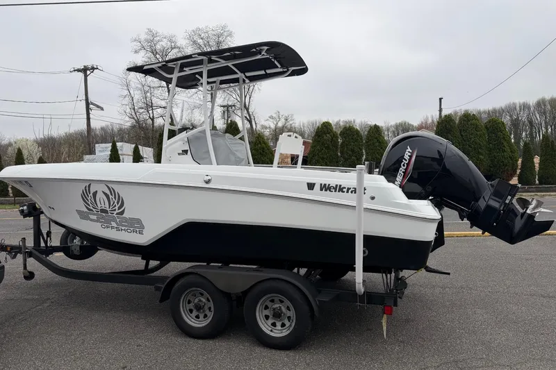 Slide: The Image of 2021 Wellcraft 202 Fisherman boat on trailer with Mercury outboard motor. - 2